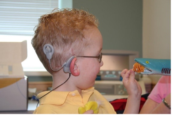 A child that has a cochlear implant.