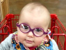 Baby wearing purple glasses