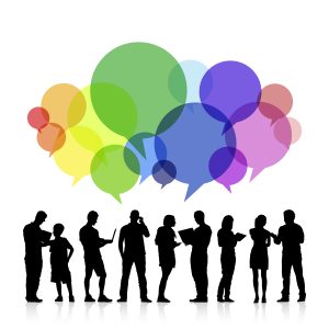 Silhouetted group of people standing and talking, with colorful speech bubbles above their heads in green, blue, purple, pink, and orange.