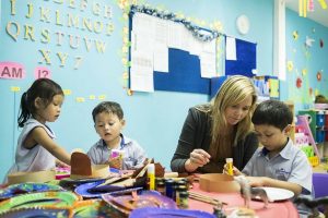 Teacher working with three children