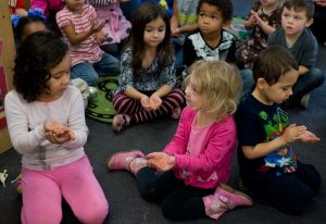 Group of children learning about handwashing to prevent the spread of illness.