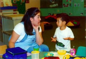 Teacher and child conversing at snack time