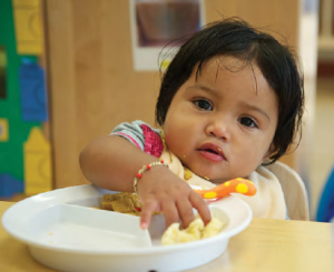 Infant feeding herself