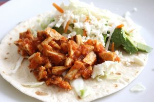 tofu, cabbage, avocado, cheese on a tortilla