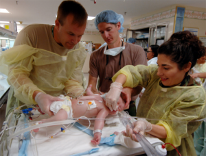 Three medical professionals trying to save an infant who was shaken.