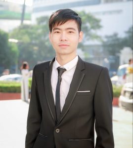 student in suit standing outside