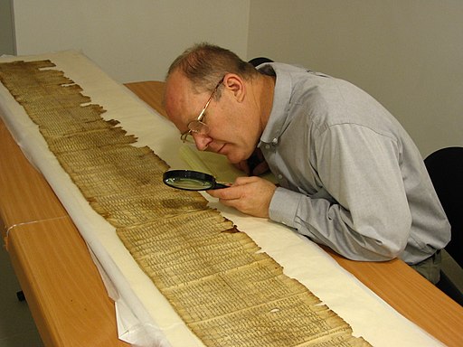 Parry studies the Great Isaiah Scroll (1QIsa-a) in the Dead Sea Scrolls vault (scrollery), Israeli Museum, Jerusalem, Israel.