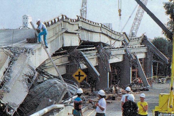 Photograph of the collapsed freeway in Oakland, California. The freeways was a double layered road and the support beams between the two layers completely buckled allowing the top layers to fall flat onto the bottom layer