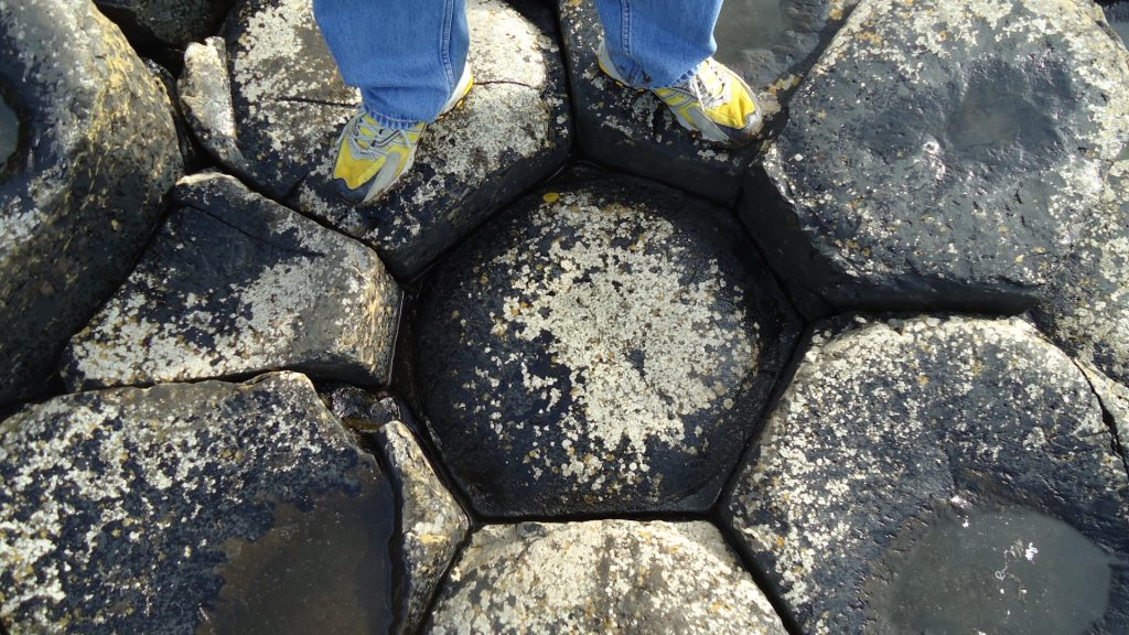 Photograph of columnar joints viewed from above. Columnar jointing looks like hexagons packed tightly together.