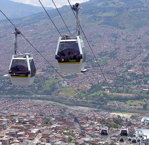 Photograph of the gondola system lifting passengers up to the mountainside communities