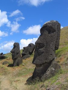 Large stone faces carved from rock along a hillside